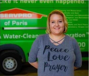 Female Employee Smiling in front of SERVPRO vehicle