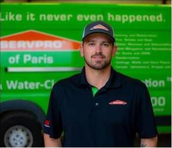 Male Employee Smiling in front of SERVPRO vehicle
