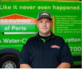 Male Employee Smiling in front of SERVPRO vehicle