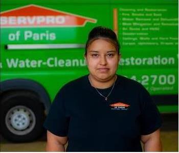 Female Employee Smiling in front of SERVPRO vehicle